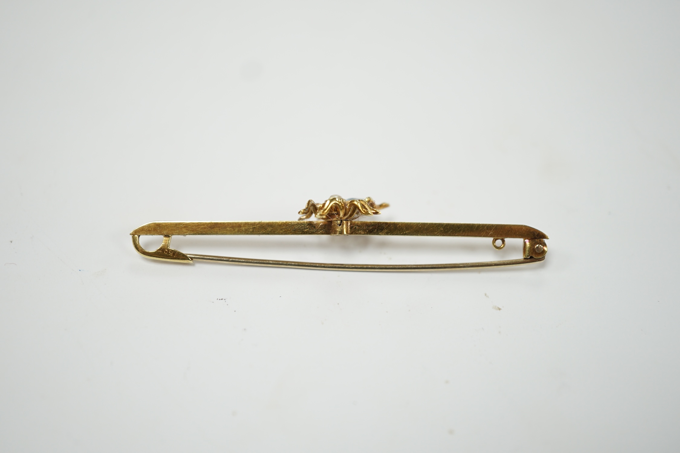 A yellow metal, aquamarine and seed pearl set spider bar brooch, 57mm, gross weight 3.5 grams. Good condition.